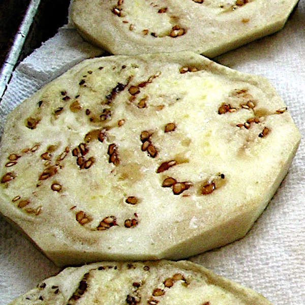 Salt drawing out droplets of moisture on eggplant