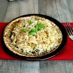 Easy Rice Pilaf on a brown plate with a red napkin in the background