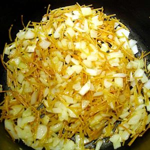 Sauteeing the pasta and vegetables